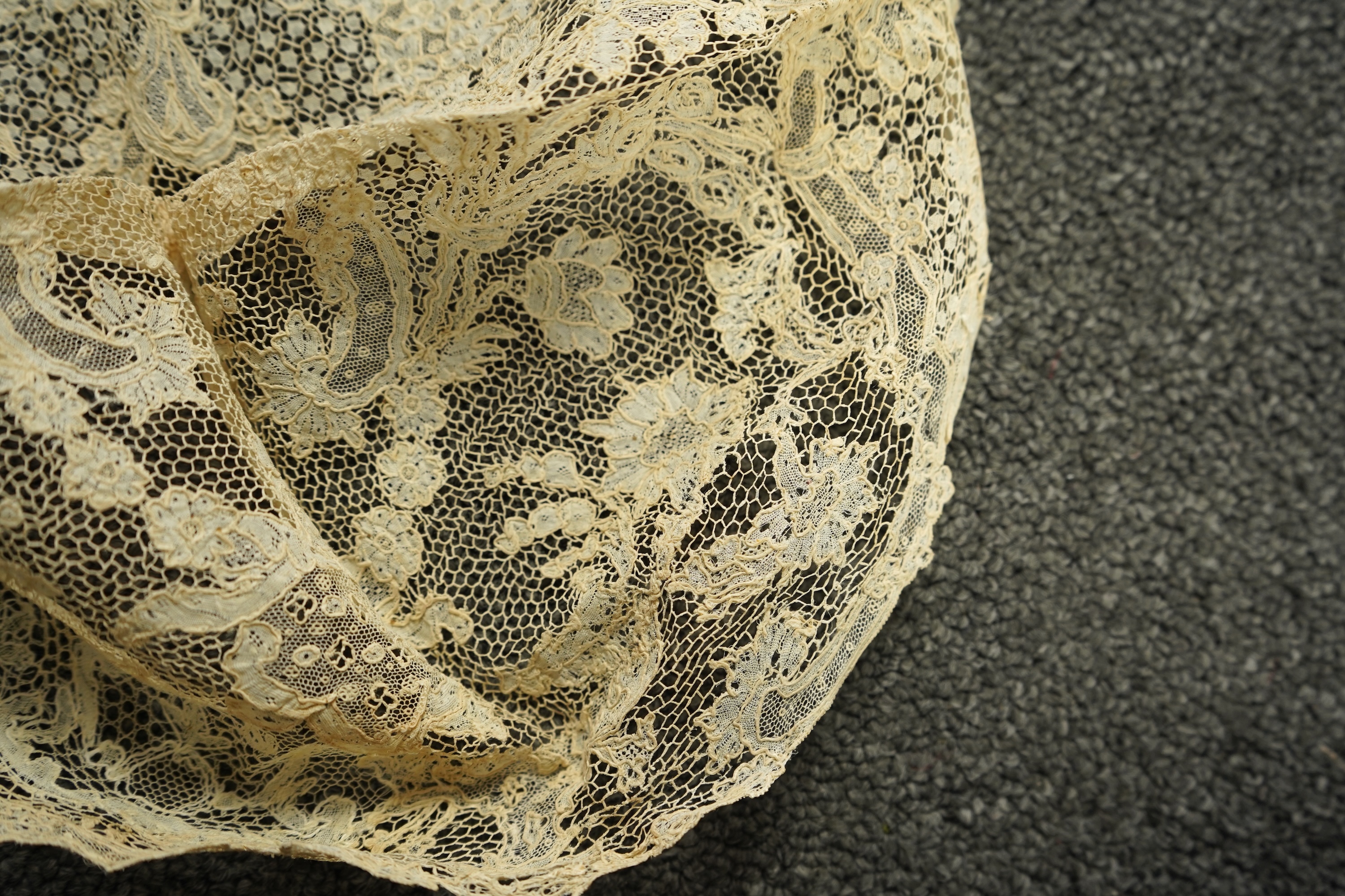A collection of 18th century needle and bobbin lace. Including an 18th century wide pair of joined Valenciennes lace lappets, a similar 18th century cap back, an ornately worked Point de Alencon cap crown and another sim
